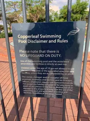 a sign on a fence with a sign on it at Golf Suites @ Copperleaf in Centurion
