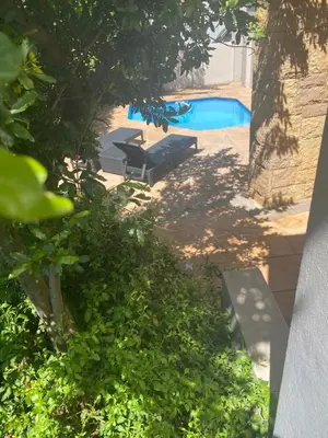 a view of a swimming pool with a bench in a yard at Golf Suites @ Copperleaf in Centurion