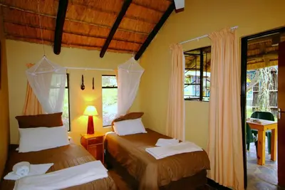 a bedroom with two beds and a window at Timbavati Safari Lodge in Mbabat