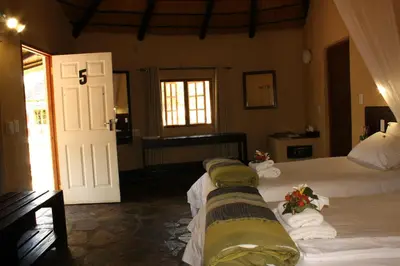a bedroom with two beds with flowers on them at Timbavati Safari Lodge in Mbabat