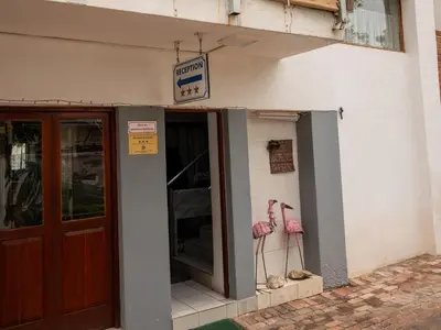a building with a door and a sign on it at Sleepers Villa Guesthouse in Polokwane