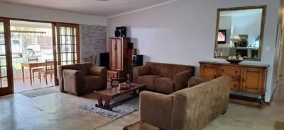 a living room with two chairs and a table at 1@Kruger in Mokopane