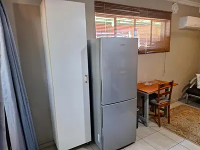 a stainless steel refrigerator in a kitchen with a table at 1@Kruger in Mokopane