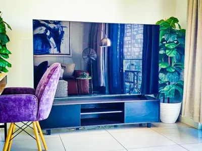 a living room with a table and two chairs at Luxurious, affordable Ellipse apartment in Midrand