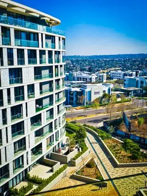 a tall building with a view of a city at Luxurious, affordable Ellipse apartment in Midrand