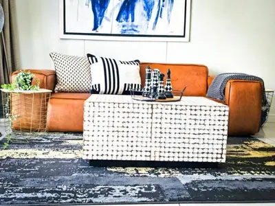 a living room with a couch and a coffee table at Luxurious, affordable Ellipse apartment in Midrand