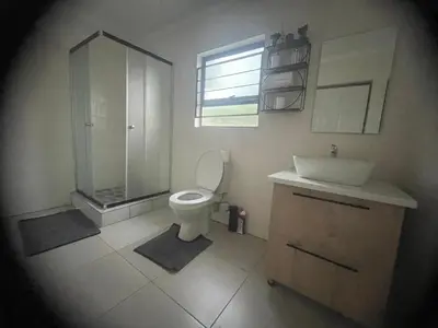 a bathroom with a toilet and a shower and a sink at Masana at Homely Escape in Phalaborwa