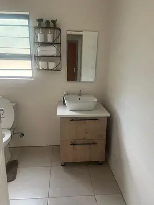 a bathroom with a sink and a mirror at Masana at Homely Escape in Phalaborwa