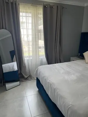 a bedroom with a bed and a large window at Masana at Homely Escape in Phalaborwa