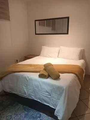 a bedroom with a large bed with two towels on it at 612 @ Leisure Bay in Pretoria