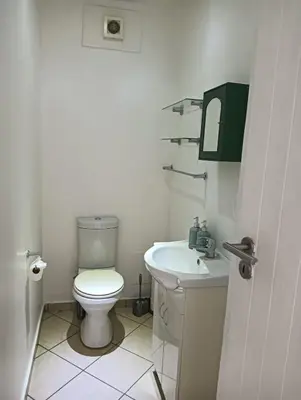a white bathroom with a toilet and a sink at 612 @ Leisure Bay in Pretoria