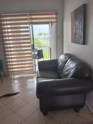 a black leather couch sitting in a living room at 612 @ Leisure Bay in Pretoria
