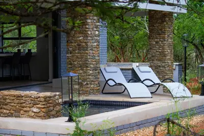 a couple of benches sitting on a patio at Ungava Retreat in Marloth Park