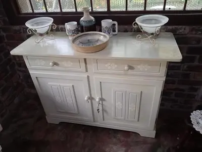 a white cabinet with two bowls on top of it at Hedgehog Cabin in Marloth Park