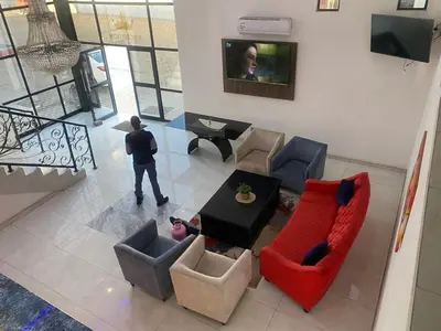 an overhead view of a living room with a red couch and chairs at Hotel El Infinito in Kempton Park