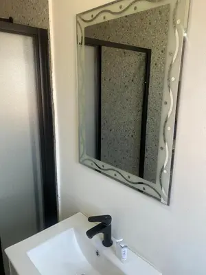 a bathroom with a sink and a mirror at Hotel El Infinito in Kempton Park