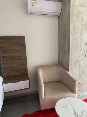a room with a chair and a table at Hotel El Infinito in Kempton Park