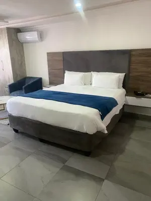 a bedroom with a large bed in a room at Hotel El Infinito in Kempton Park