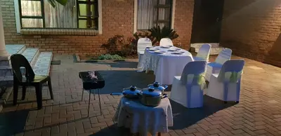 a group of tables and chairs in a courtyard at Molata Rabs in Polokwane
