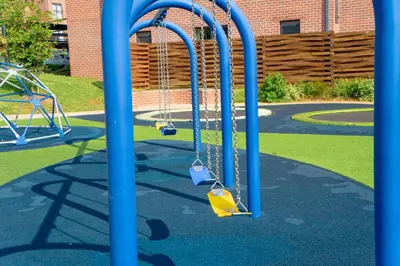 a playground with two swings in a park at Secure 1 Bedroom Apartment in Midrand, Waterfall City - Lock Up and Go - Free WIFI and Parking - 9 Elizabeth Place in Midrand