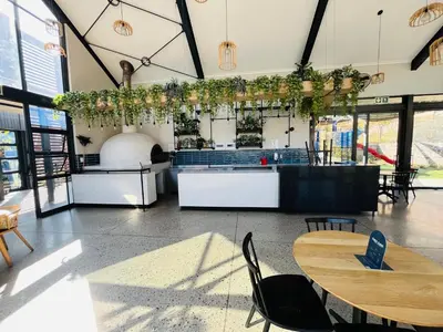 a restaurant with tables and chairs in a room at 4 Elizabeth Place - Beautiful 1 bedroom unit next to Kyalami Racetrack with free WiFi swimming pool gym and restaurant - Perfect for a Couple in Midrand Waterfall in Midrand