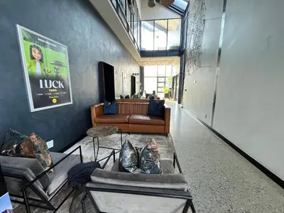 a living room with couches and a couch at 10 Elizabeth Place - Beautiful self catering 2 bedroom unit next to Kyalami Racetrack with free WiFi swimming pool gym and restaurant - Perfect for a small family in Midrand Waterfall in Midrand