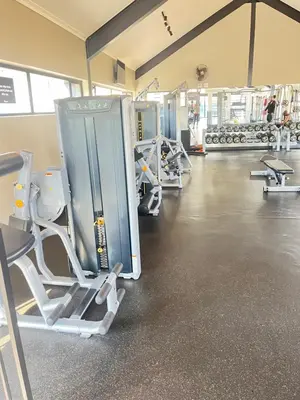 a gym with a row of treadmills and machines at 10 Elizabeth Place - Beautiful self catering 2 bedroom unit next to Kyalami Racetrack with free WiFi swimming pool gym and restaurant - Perfect for a small family in Midrand Waterfall in Midrand