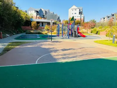 a playground in a park with a playground at 10 Elizabeth Place - Beautiful self catering 2 bedroom unit next to Kyalami Racetrack with free WiFi swimming pool gym and restaurant - Perfect for a small family in Midrand Waterfall in Midrand