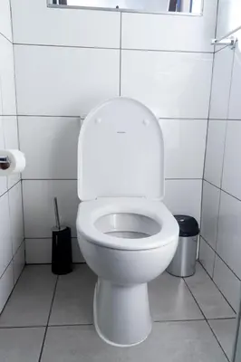 a white toilet in a white tiled bathroom at Spacious 2 Bedroom Apartment in Midrand, Waterfall City - Business and Family friendly - 11 Elizabeth Place in Midrand
