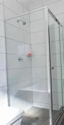 a bathroom with a shower with a glass door at Spacious 2 Bedroom Apartment in Midrand, Waterfall City - Business and Family friendly - 11 Elizabeth Place in Midrand