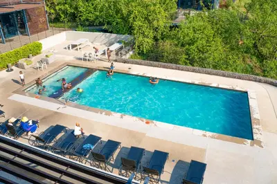 an overhead view of a swimming pool with people in chairs at Spacious 2 Bedroom Apartment in Midrand, Waterfall City - Business and Family friendly - 11 Elizabeth Place in Midrand