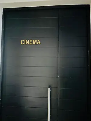 a black garage door with the word cinema on it at Spacious 2 Bedroom Apartment in Midrand, Waterfall City - Business and Family friendly - 11 Elizabeth Place in Midrand