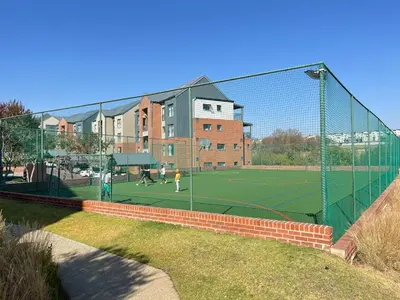 a tennis court with people playing tennis on a court at Spacious 2 Bedroom Apartment in Midrand, Waterfall City - Business and Family friendly - 11 Elizabeth Place in Midrand