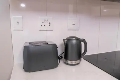 a toaster and a toaster sitting on a counter at Spacious 2 Bedroom Apartment in Midrand, Waterfall City - Business and Family friendly - 11 Elizabeth Place in Midrand