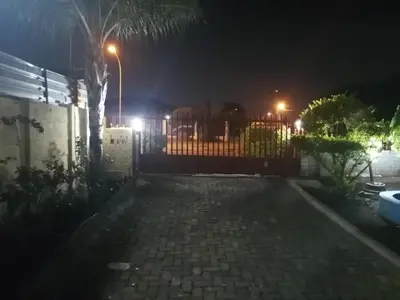 a fence in front of a house at night at GLORIA'S GUESTS.COM in Polokwane