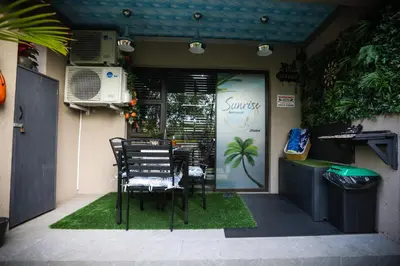a table and chairs sitting outside of a restaurant at Air-Conditioned, Self-Catering Apartment with Heated Pool Near OR Tambo International Airport in Benoni