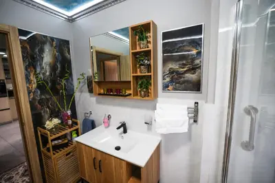 a bathroom with a sink and a shower at Air-Conditioned, Self-Catering Apartment with Heated Pool Near OR Tambo International Airport in Benoni