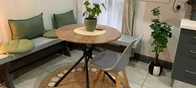 a small table and chairs in a room with a bed at Forest Hill in Pretoria