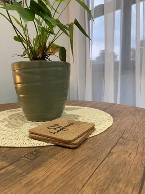 a napkin sitting on a table next to a plant at Forest Hill in Pretoria