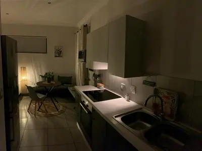 a kitchen with two sinks and a table in a room at Forest Hill in Pretoria
