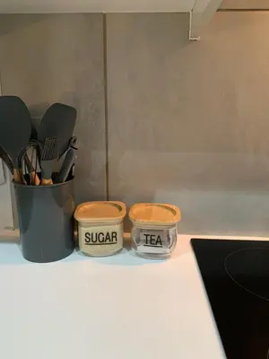 two containers of sugar and tea sitting on a counter at Forest Hill in Pretoria