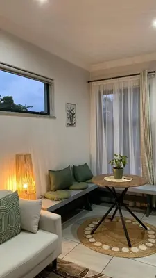 a living room with a couch and a table at Forest Hill in Pretoria