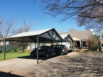 a car parked under a canopy in front of a house at 40 on Ilkey B&B in Pretoria