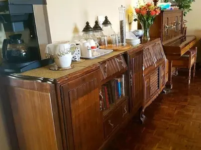 a wooden cabinet with dishes on top of it at 40 on Ilkey B&B in Pretoria