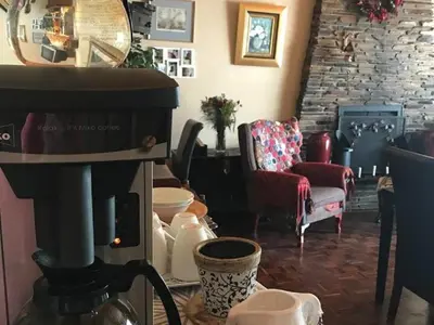 a living room with a coffee maker and a couch at 40 on Ilkey B&B in Pretoria