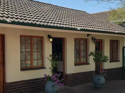 a small house with flowers in front of it at 40 on Ilkey B&B in Pretoria