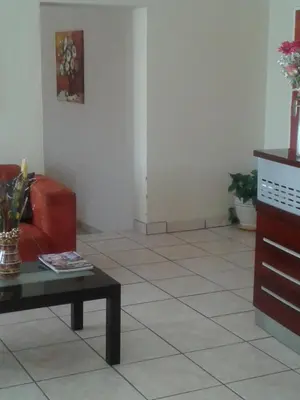 a living room with a couch and a coffee table at Turquoise View Guesthouse in Middelburg
