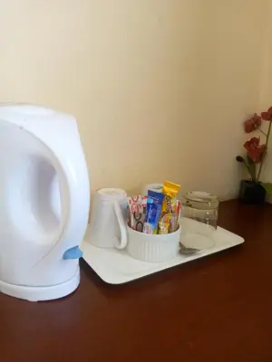 a counter with a coffee maker and a cup of candy at Turquoise View Guesthouse in Middelburg