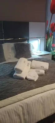 a bed with two towels and two pillows on it at Menlyn Maine Trilogy Apartment 1518 in Pretoria