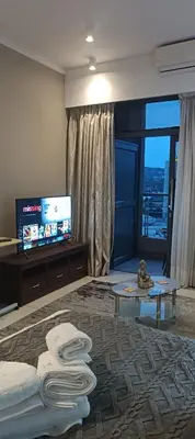 a hotel room with a bed and a flat screen tv at Menlyn Maine Trilogy Apartment 1518 in Pretoria
